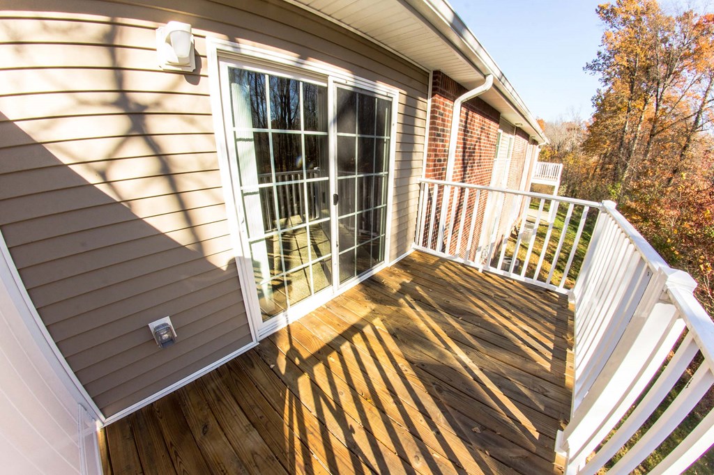 a house with a deck and a large window